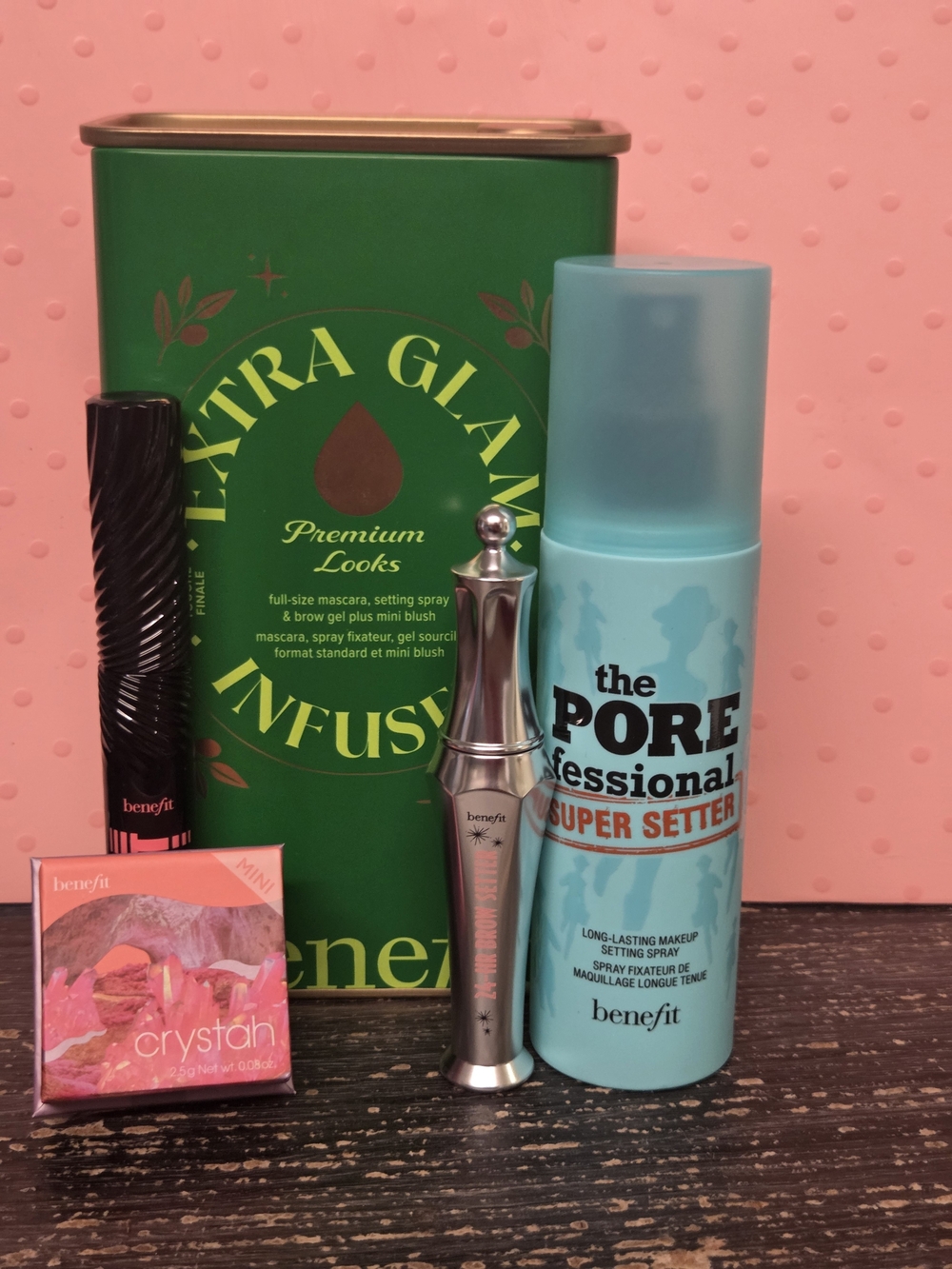 Benefit makeup collection with teal setting spray and green tin